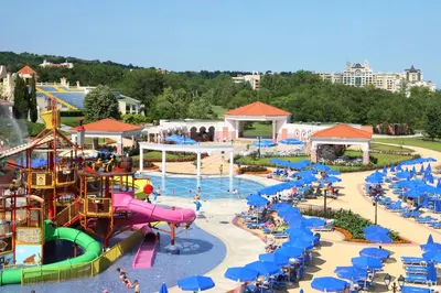 an amusement park with a water park with slides and umbrellas at Duni Marina Beach Hotel - All Inclusive in Sozopol