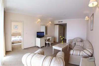 a living room with two couches and a table at Duni Marina Beach Hotel - All Inclusive in Sozopol