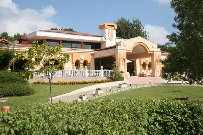 a large house with a porch and a yard at Duni Holiday Village - All Inclusive in Sozopol