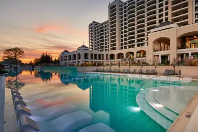 a large swimming pool in front of a large building at Secrets Sunny Beach Resort and Spa - Premium All Inclusive - Adults Only in Sunny Beach