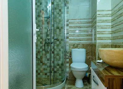 a bathroom with a toilet and a shower and a sink at Sweet Homes Apartments in Sunny Beach