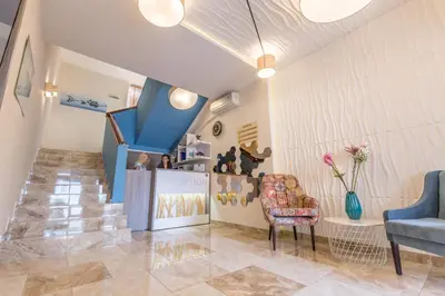 a living room with a couch and a chair at BSA Boulevard Boutique in Sunny Beach