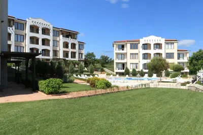a lawn in front of two large buildings at View Apartments in Sozopol