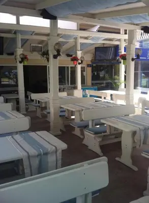 a group of tables and benches in a building at Hotel Pliska - All Inclusive Light in Sunny Beach