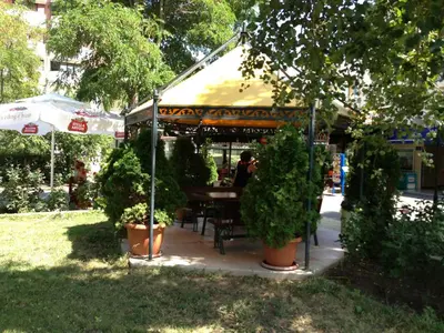 a gazebo with a table and some plants at Hotel Pliska - All Inclusive Light in Sunny Beach