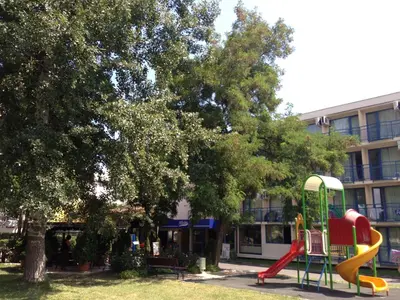 a playground with a slide in front of a building at Hotel Pliska - All Inclusive Light in Sunny Beach