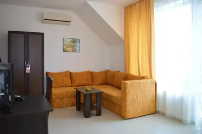 a living room with a couch and a table at Hotel Paradise in Lozenets