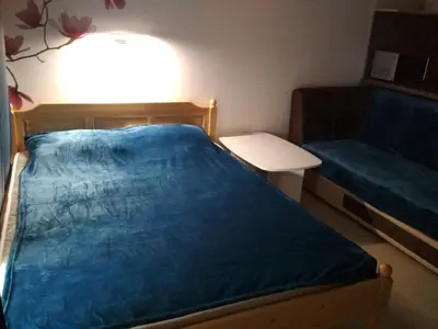 a small bedroom with a bed and a couch at Виктория in Pomorie