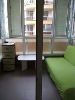 a room with a bed and a window at Виктория in Pomorie