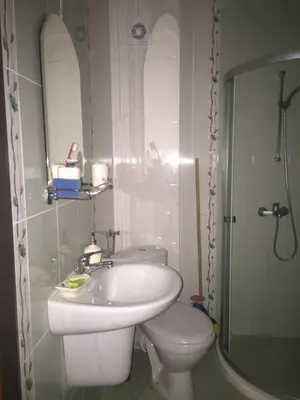 a bathroom with a sink and a toilet at Виктория in Pomorie