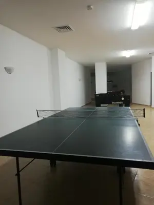 a ping pong table in the middle of a room at DEA Pasavan Apartments in Ravda