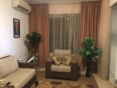 a living room with a couch and a chair at Apartment on the sea at St Nikolas Complex-Elena in Chernomorets