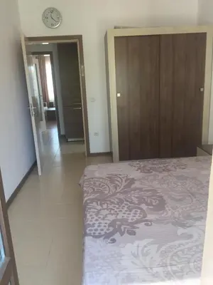 a bedroom with a bed and a clock on the wall at Apartment on the sea at St Nikolas Complex-Elena in Chernomorets