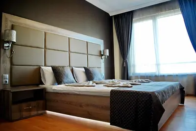 a bedroom with a large bed with a large window at Dune Boutique Pomorie in Pomorie