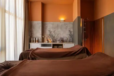a bedroom with two beds and a table in a room at AluaSoul Sunny Beach - Adults Only - All Inclusive in Sunny Beach