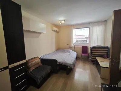 a small room with a bed and a chair at Apartment in the Center 1 in Varna City