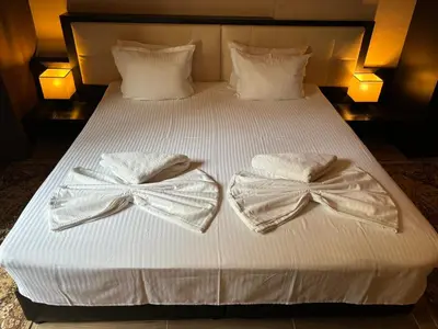 two towels on a bed with bows on them at Family Hotel Vaso in Varna City