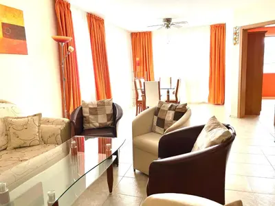 a living room with two couches and a glass table at Rusalka Apart-Residence in Obzor