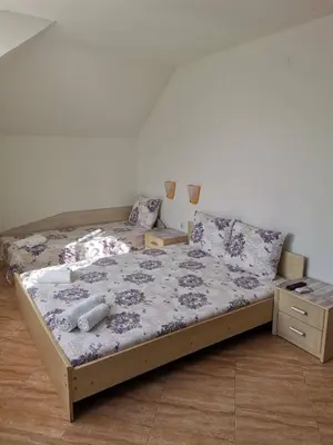 a bed in a room with two twin beds at Виктория Созопол in Sozopol