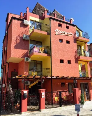 a red brick building with a nieves sign on it at Виктория Созопол in Sozopol