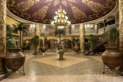 a large lobby with a chandelier and potted plants at Royal Park Hotel - All Inclusive in Elenite