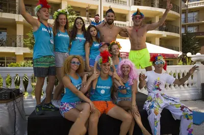 a group of people dressed in costumes posing for a picture at Royal Park Hotel - All Inclusive in Elenite