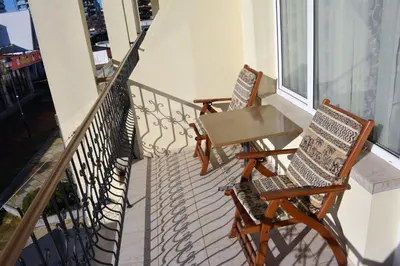 two chairs and a table on a balcony at Lotus Family Hotel - Free Parking in Sunny Beach
