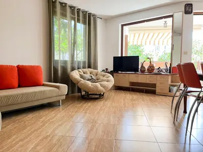 a living room with a couch and a chair at Комплекс «ТОП» in Sveti Vlas