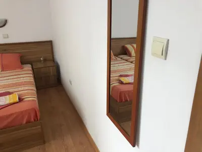 a mirror in a room with two beds at Комплекс «ТОП» in Sveti Vlas