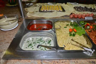 a tray of food with noodles and sauce on a table at Diamond Hotel - All Inclusive in Sunny Beach