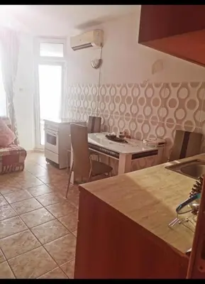 a kitchen with a table and chairs in a room at Apartment Blue Komfort in Sunny Beach