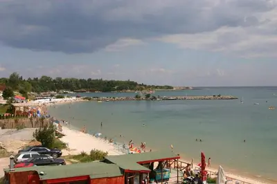 a beach with a group of people in the water at Harmony Beach Family Hotel in Nesebar