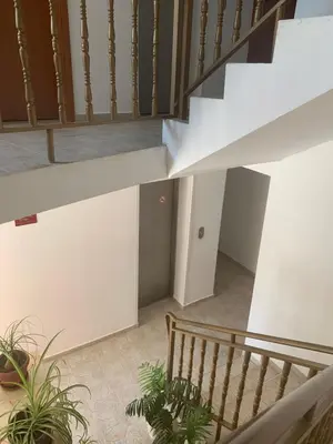 a staircase in a building with potted plants at Къща Нанси in Sunny Beach