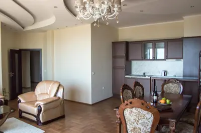 a living room with a chair and a table at Long Beach Resort in Shkorpilovtsi