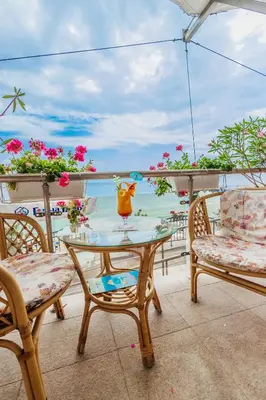 a table and chairs on a balcony with the ocean at Mirage Hotel in Nesebar