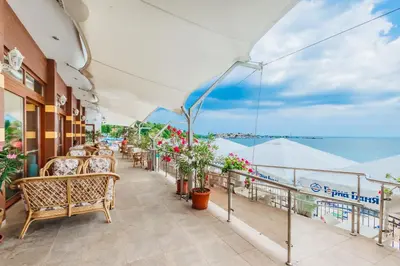 a balcony with chairs and a view of the ocean at Mirage Hotel in Nesebar