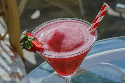 a red drink with a strawberry in a glass at Mirage Hotel in Nesebar