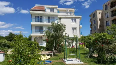 a building with a swing in front of it at Lilia Guest House in Nesebar