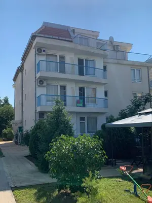 a large white building with balconies on it at Lilia Guest House in Nesebar