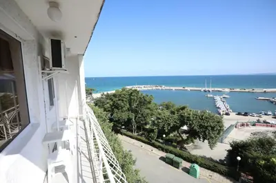 a balcony of a building with a view of a harbor at Family Hotel White House in Pomorie
