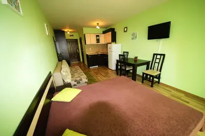 a living room with a bed and a kitchen at Amadeus Lux - Menada Apartments in Sunny Beach