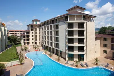 a hotel with a large swimming pool next to a building at Amadeus Lux - Menada Apartments in Sunny Beach