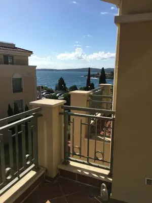 a balcony of a building with a view of the ocean at FLORES GARDEN SEA VIEW APARTMENT WITH BALCONY in Chernomorets