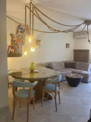 a living room with a table and chairs and a couch at FLORES GARDEN SEA VIEW APARTMENT WITH BALCONY in Chernomorets
