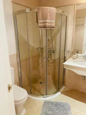 a bathroom with a shower with a toilet and a sink at FLORES GARDEN SEA VIEW APARTMENT WITH BALCONY in Chernomorets