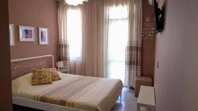 a bedroom with a bed and a large window at Ethno guest suite in Primorsko