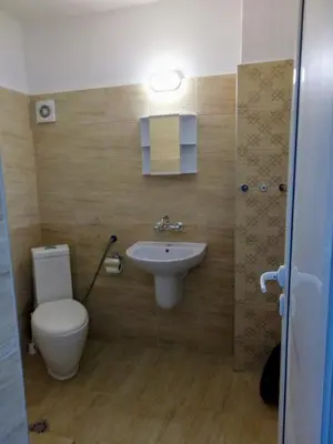a bathroom with a toilet and a sink at Ethno guest suite in Primorsko