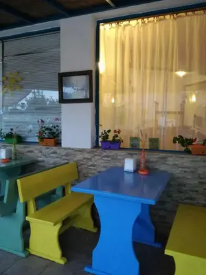 a colorful table and bench in a restaurant at Ethno guest suite in Primorsko