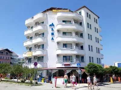 a white building with a blue cross on it at Ethno guest suite in Primorsko