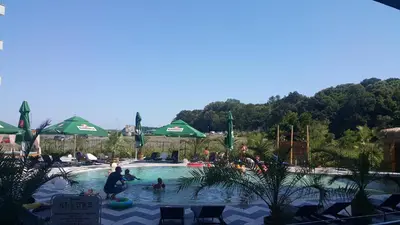 a group of people in a pool at a resort at Allure Beach Resort Aparthotel in Primorsko
